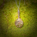 Decorative pendant with a circular design on a green moss background