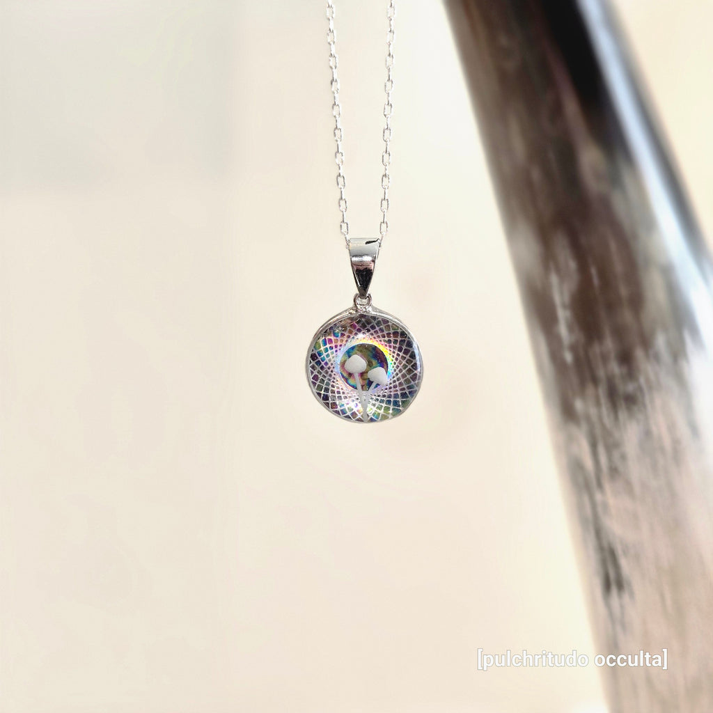 Silver necklace with a colorful pendant on a light background