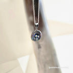 Silver necklace with a round pendant on a blurred background