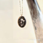 Necklace with a pendant featuring mushrooms on a white background