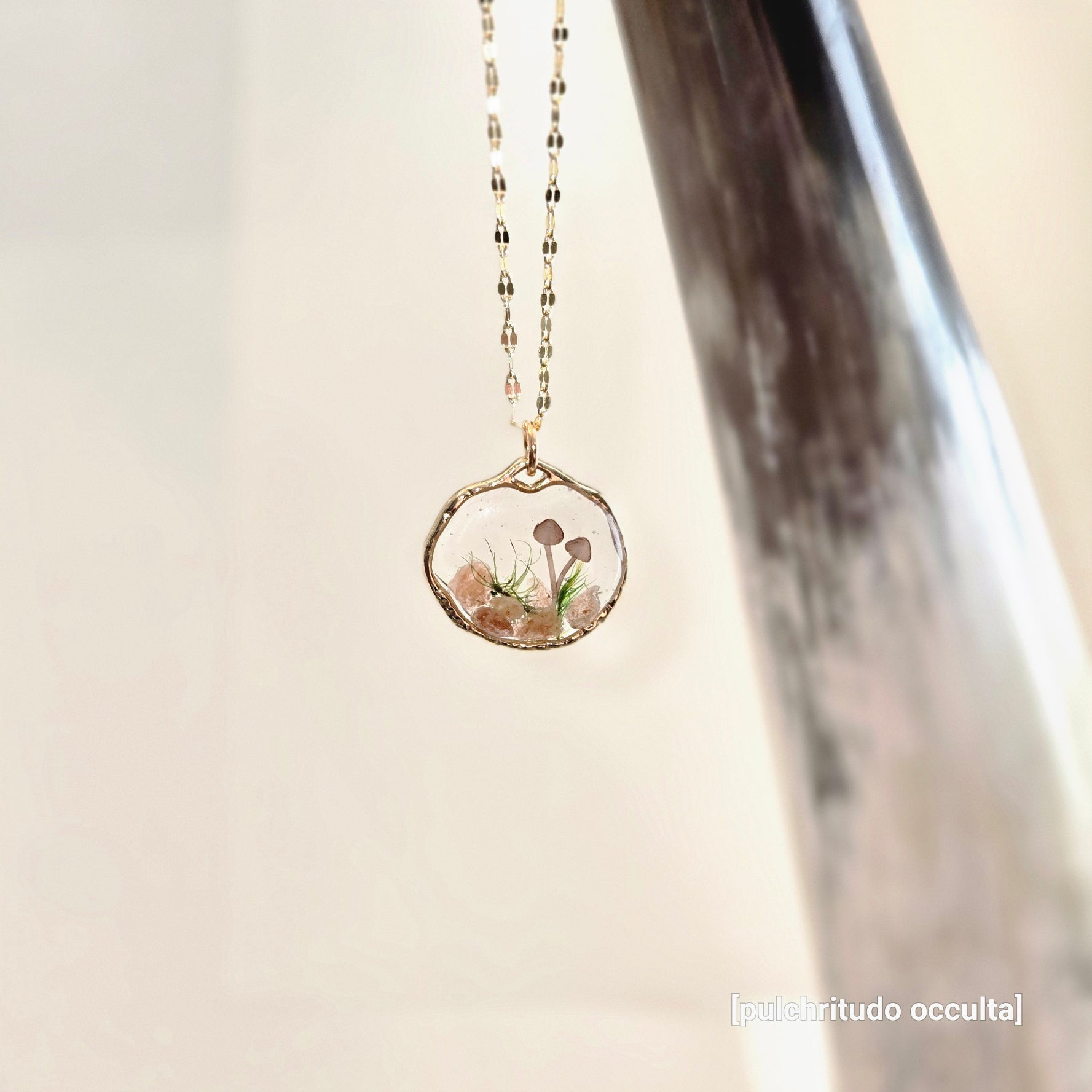 Necklace with a natural-shaped pendant featuring a floral design on a neutral background