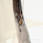 Gold necklace with a triangular pendant 