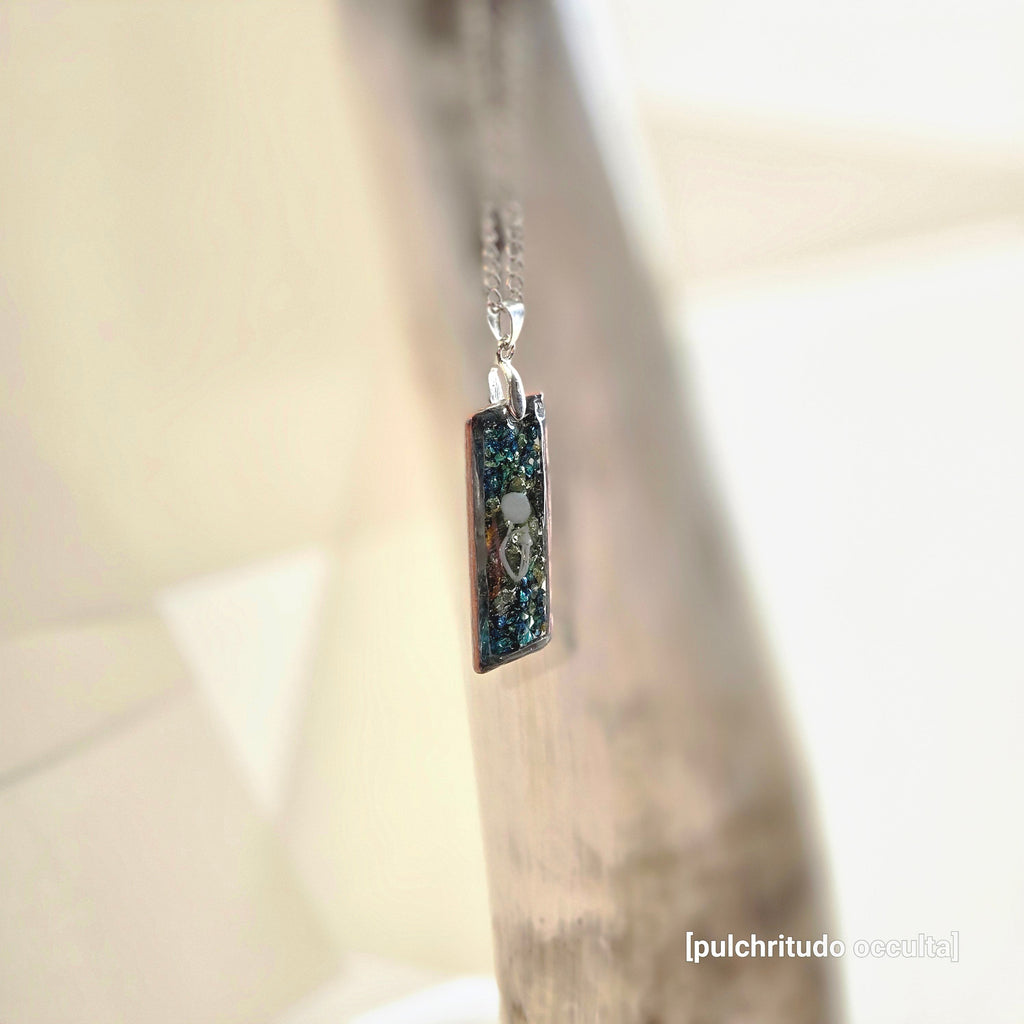 Silver necklace with a rectangular pendant with a metallic background