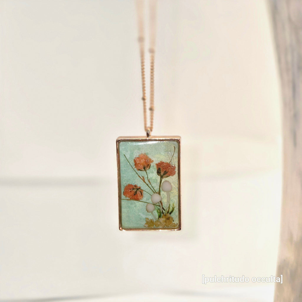 Necklace with a pendant featuring floral design on a light background