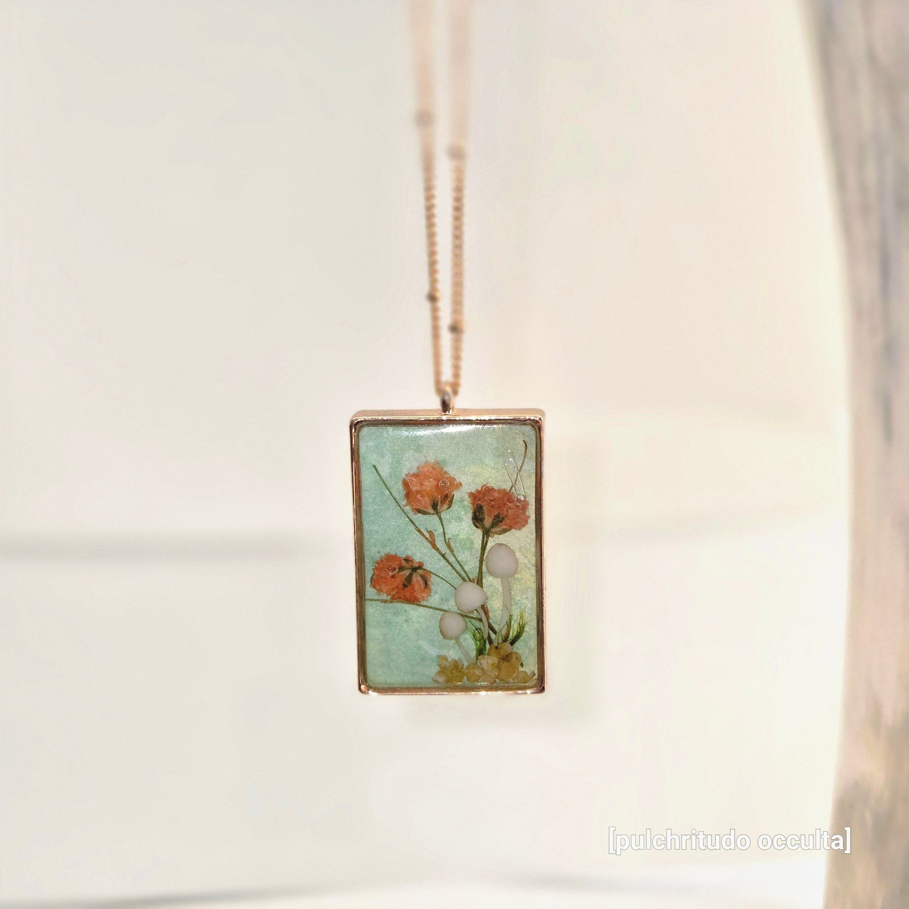 Necklace with a pendant featuring floral design on a light background
