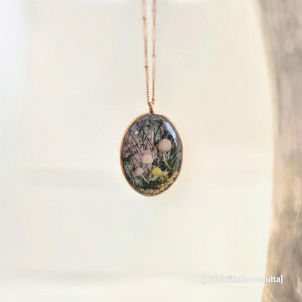 Necklace with a pendant featuring nature-themed design on a light background