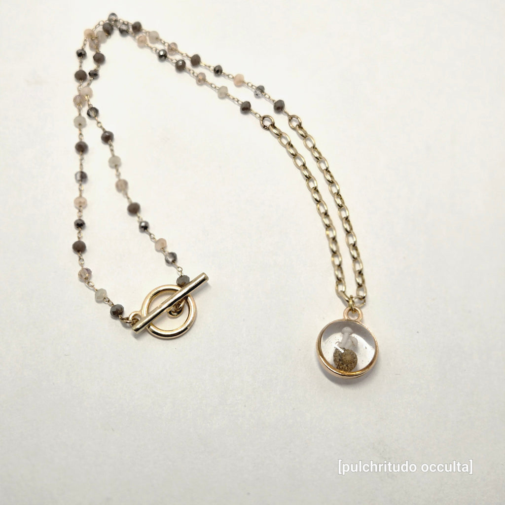 Necklace with a round pendant on a light background