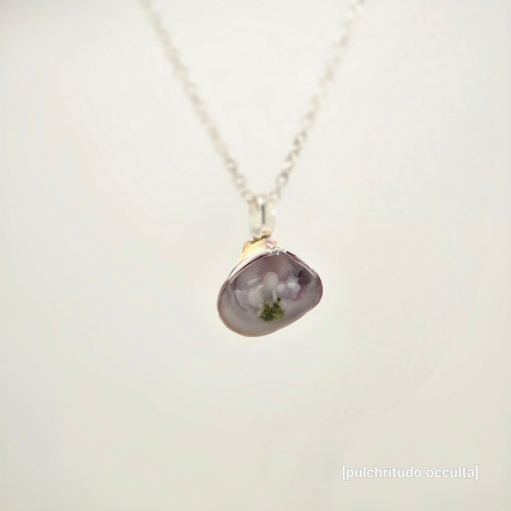 Necklace with a purple pendant on a white background