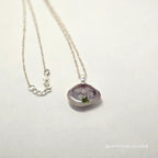 Necklace with a purple pendant on a white background