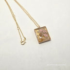 Necklace with a decorative pendant on a white background