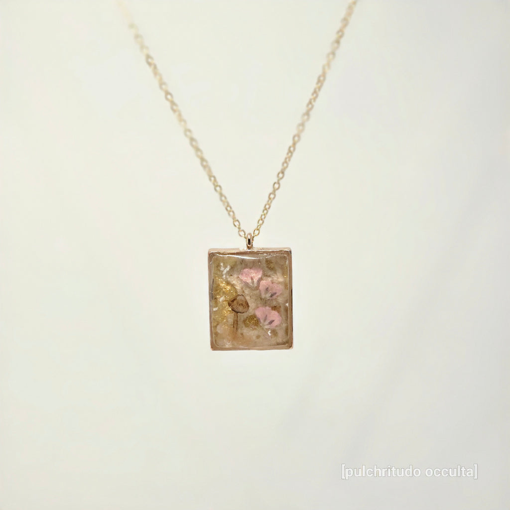 Necklace with a square pendant featuring floral design on a light background