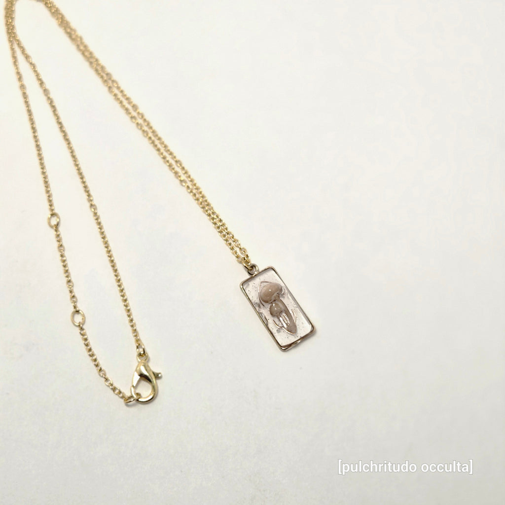 Gold chain necklace with a clasp on a light gray background