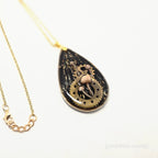 Steampunk-style necklace with gear design on a white background