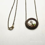 Necklace with a round pendant on a white background