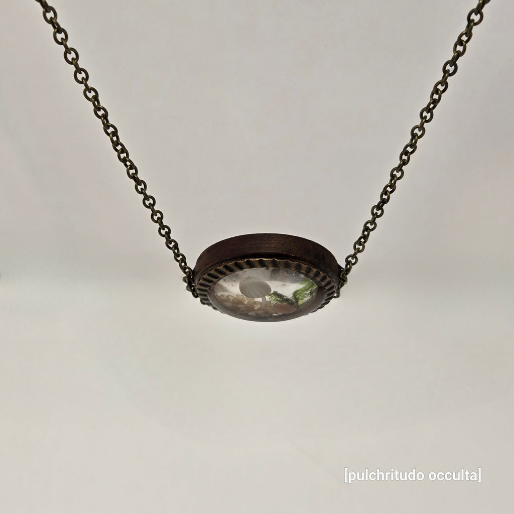 Necklace with a round pendant on a light gray background