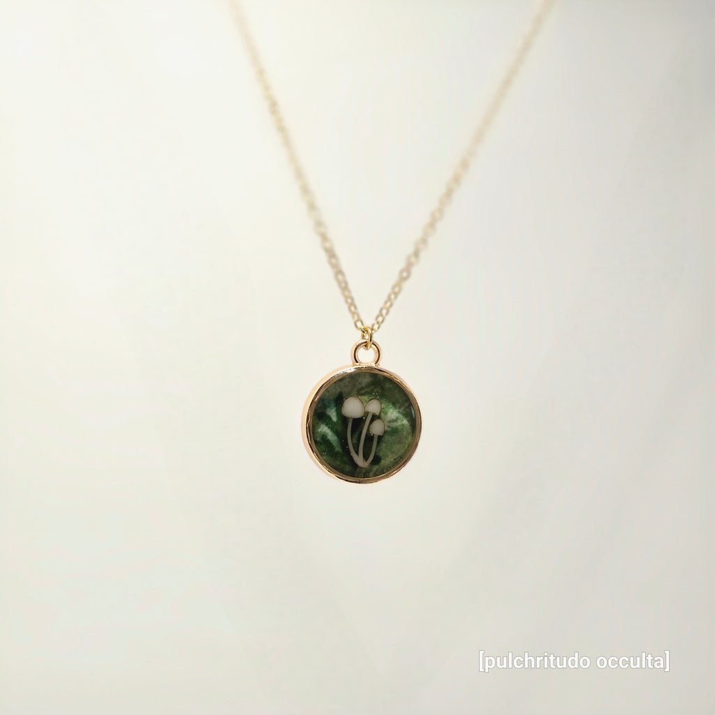 Necklace with a round pendant featuring a floral design on a light background