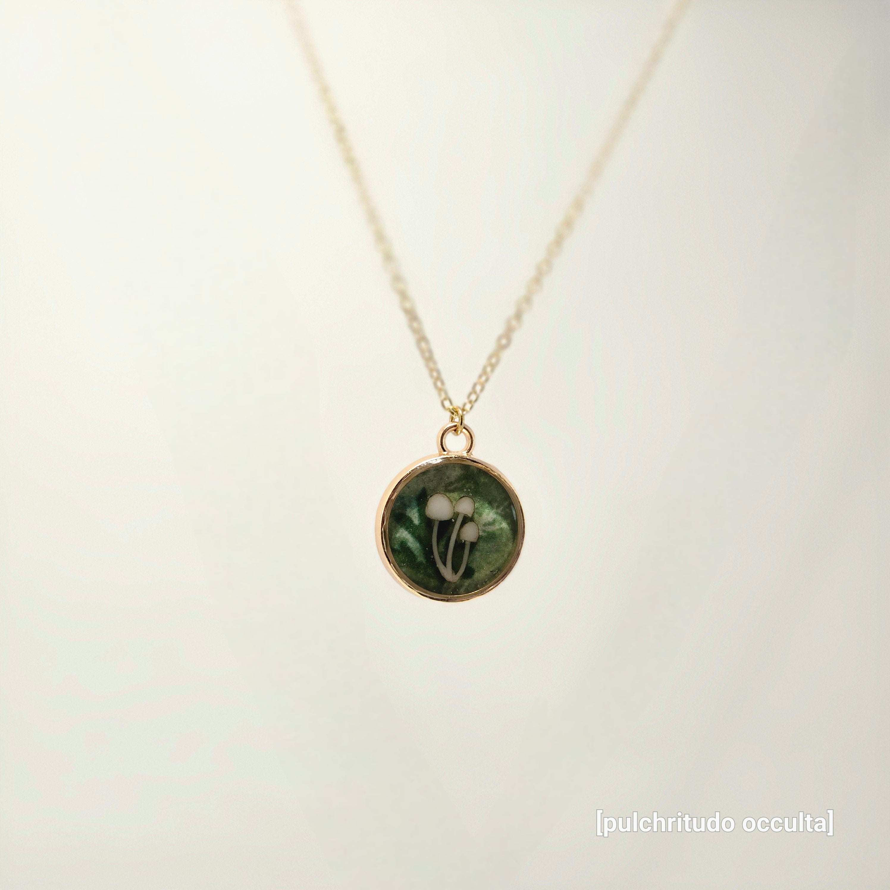 Necklace with a round pendant featuring a floral design on a light background