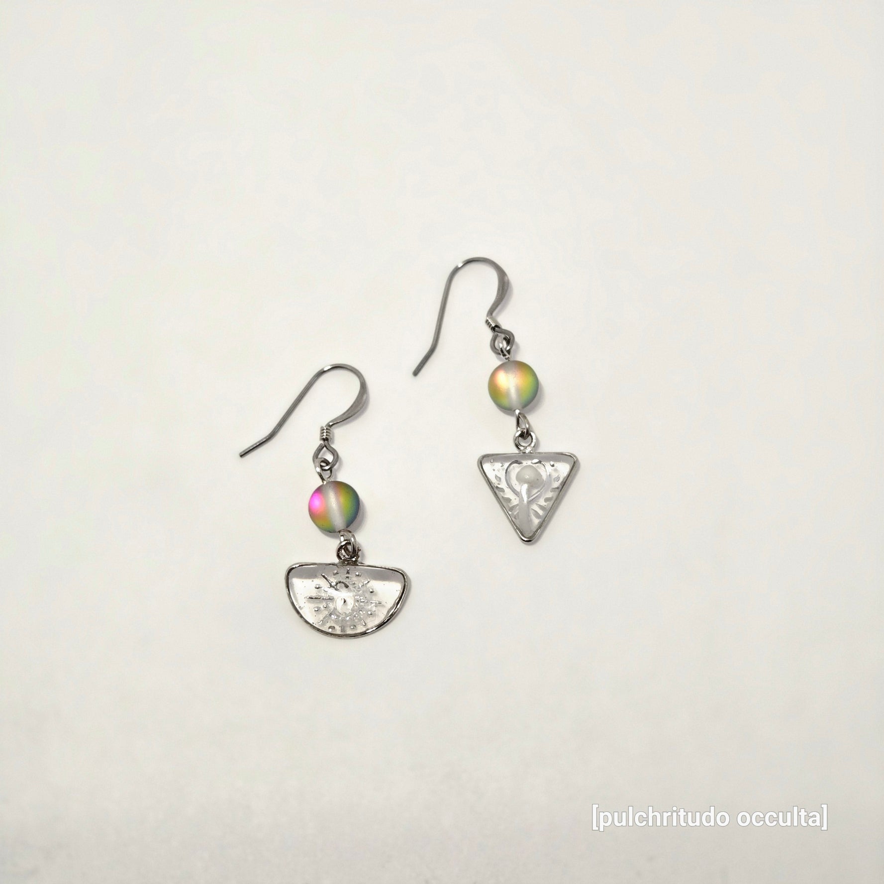 Pair of silver earrings with colorful beads on a light gray background