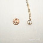 Gold chain with a round pendant on a white background