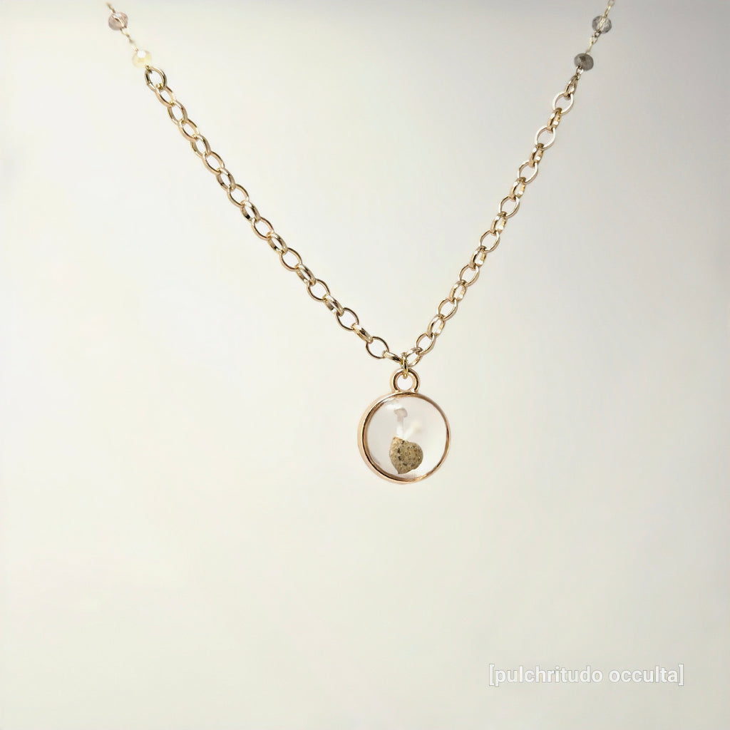 Necklace with a round pendant on a light gray background
