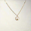 Necklace with a round pendant on a light gray background