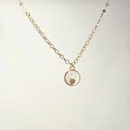 Necklace with a round pendant on a light gray background