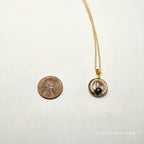 Gold necklace with a pendant on a white background