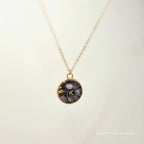 Necklace with a round pendant on a light beige background