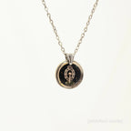 Necklace with a round pendant on a white background