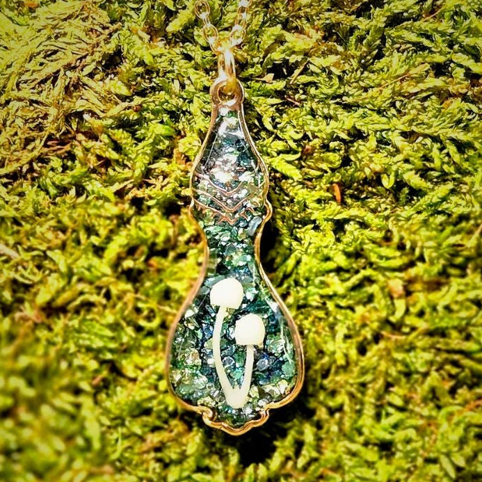 Necklace with a pendant on a green moss background