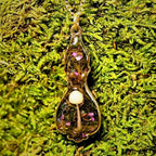 Necklace with a pendant on a green moss background