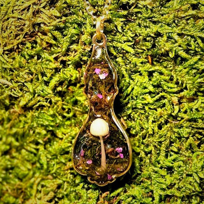 Necklace with a pendant on a green moss background