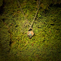Necklace with a pendant on a green moss background
