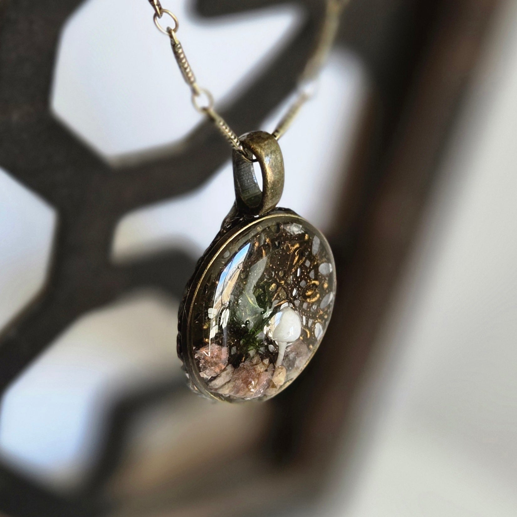 Close-up of a pendant with a blurred natural background