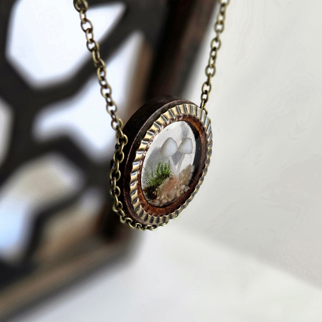 Necklace with a round pendant featuring a natural scene on a blurred background