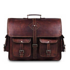A dark brown distressed leather briefcase with a top handle, front flap, two front pockets with buckle closures, and a central vertical strap detail, shown on a plain white background.
