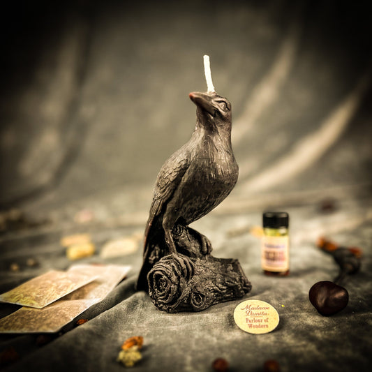 Candle-shaped sculpture of a bird on a rose with a blurred background