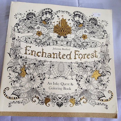 Coloring book titled 'Enchanted Forest' by Johanna Basford on a light purple background